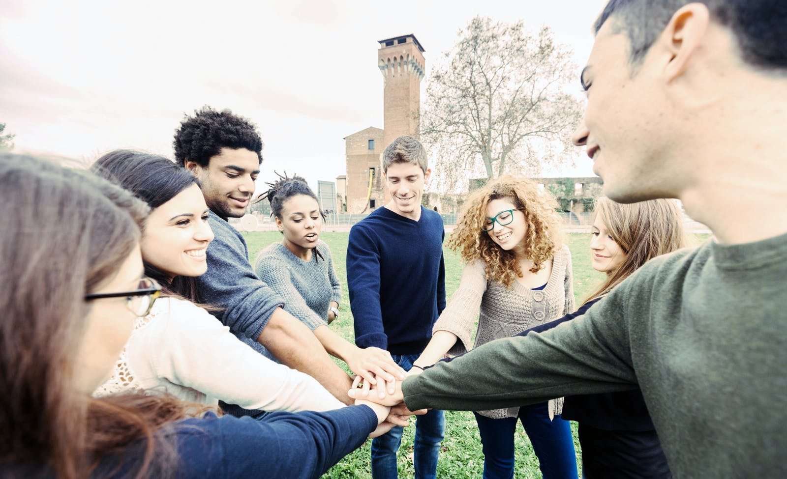 students holding hands in a circle 