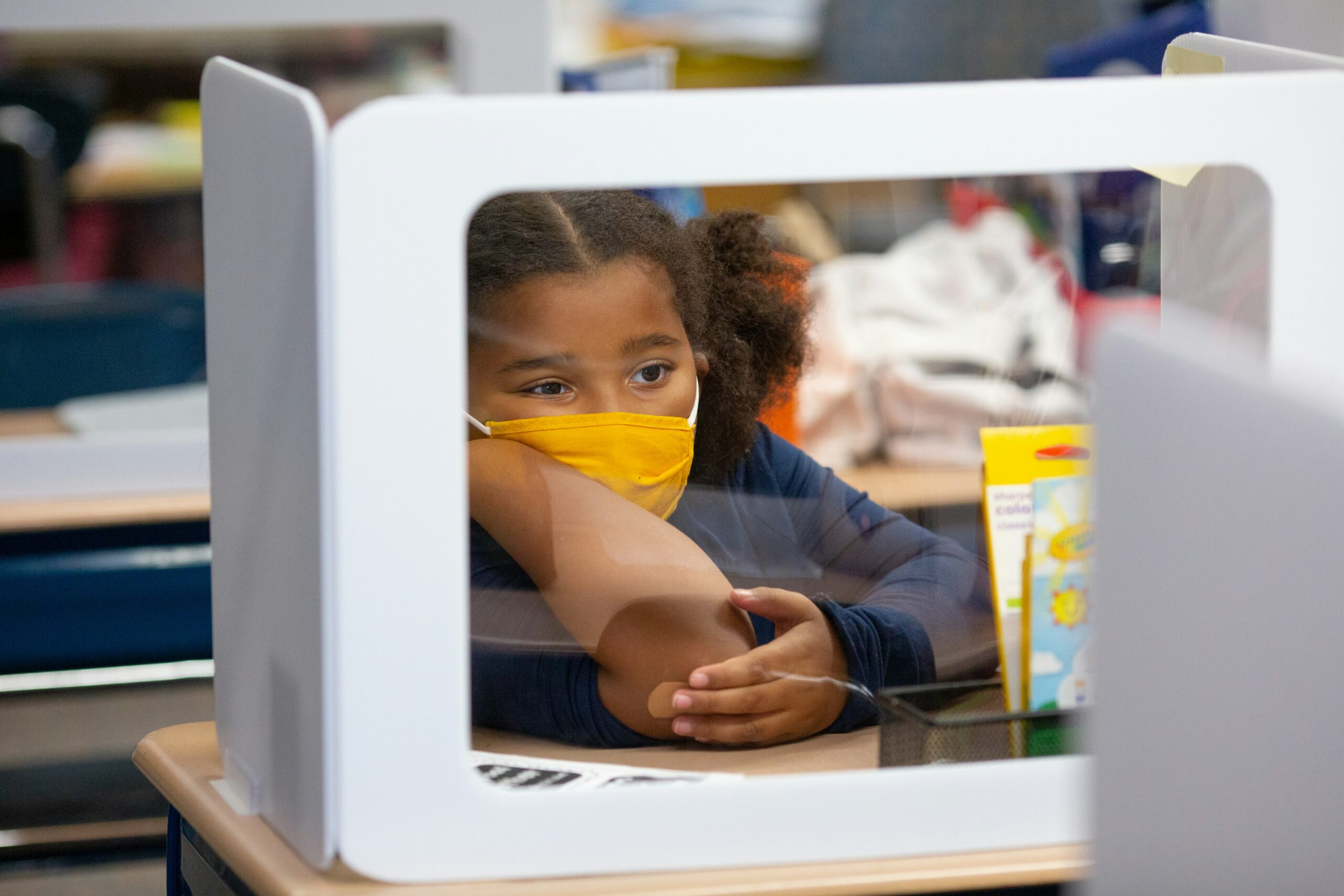 Student with mask at desk