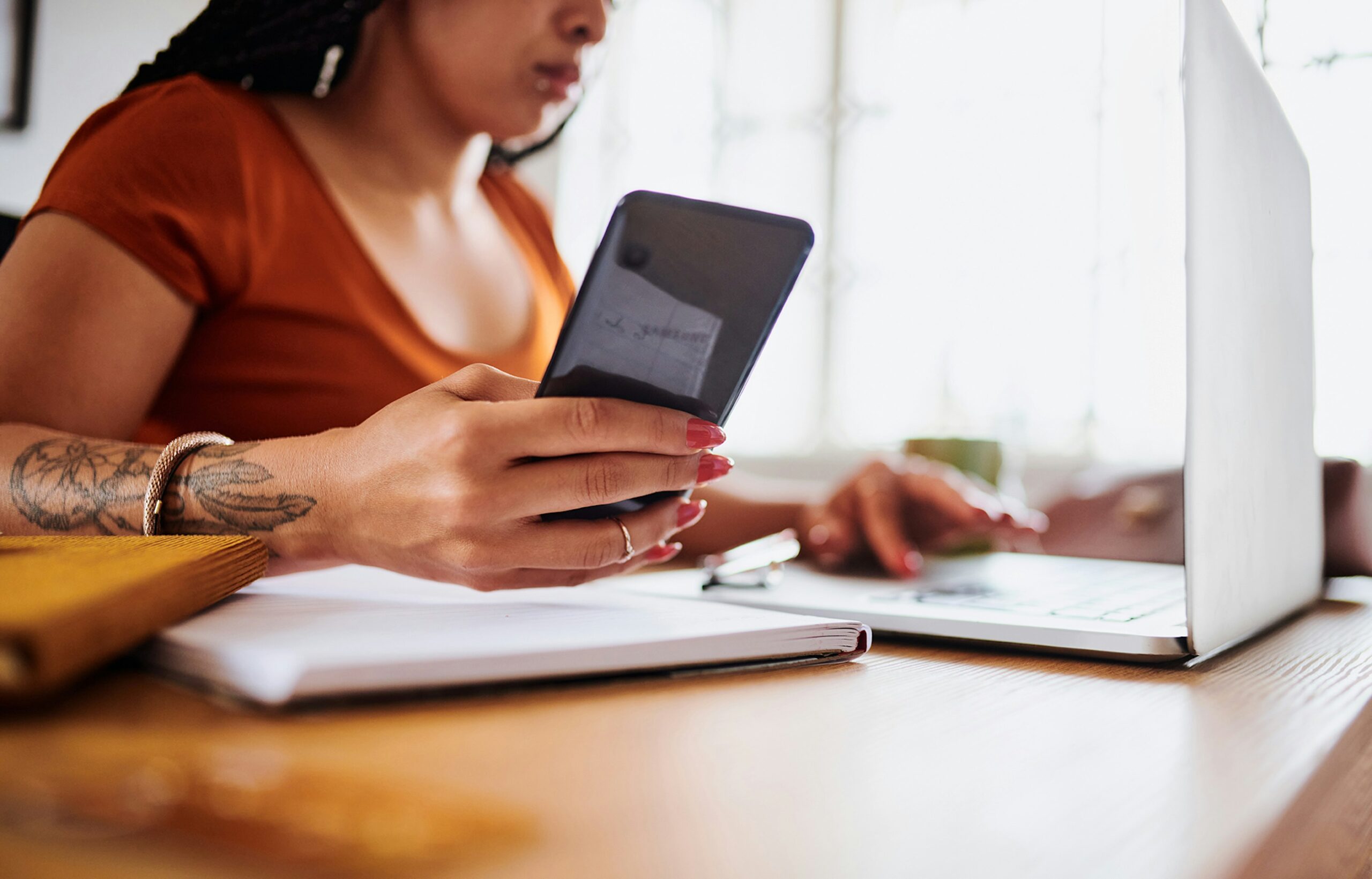 Woman on Cell Phone and Laptop