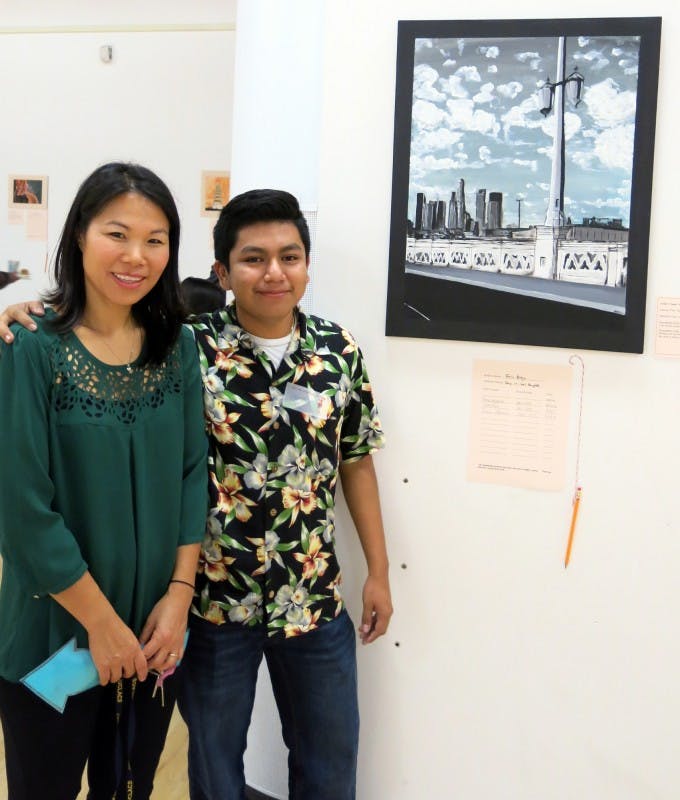 UCLA Community School art teacher Grace Maddox, with Eric Alejo and his &quot;Sunny Day in Los Angeles.&quot;