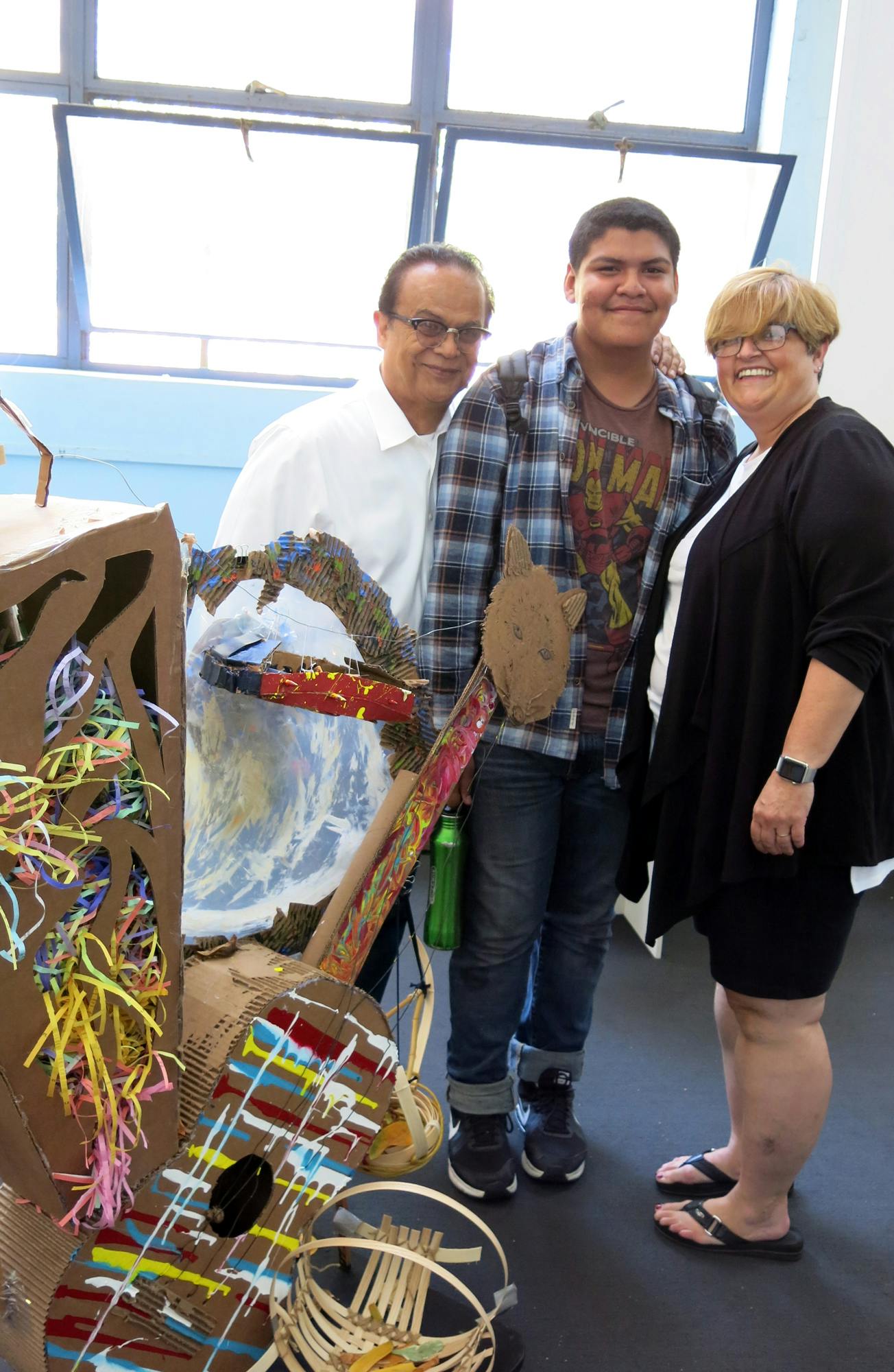 Ben Refuerzo (at left) and Agnes Cesare, UCLA Community School counselor, celebrate Michael Aguilar's completion of the FORM Academy.