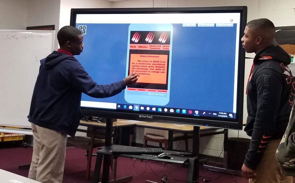 High school students in Mississippi presenting on a smart board