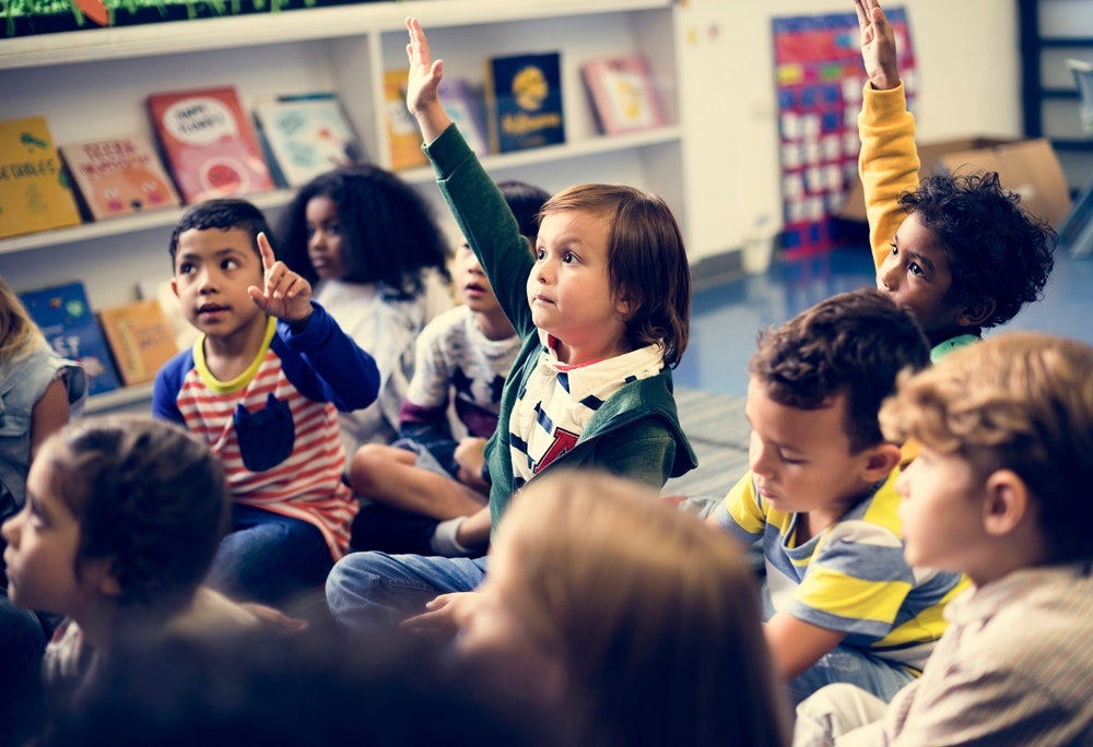 Child Raising Hand in Classroom