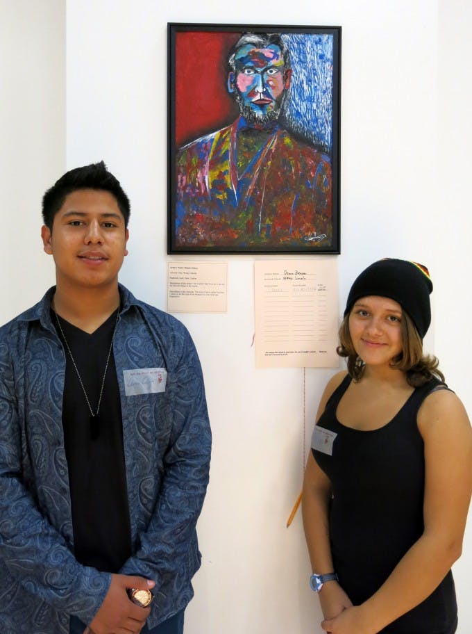 Osmin Zelaya (at left) painted a Fauvist portrait of Abraham Lincoln that sold for $150. Pictured with fellow student artist Chelsea Reel.