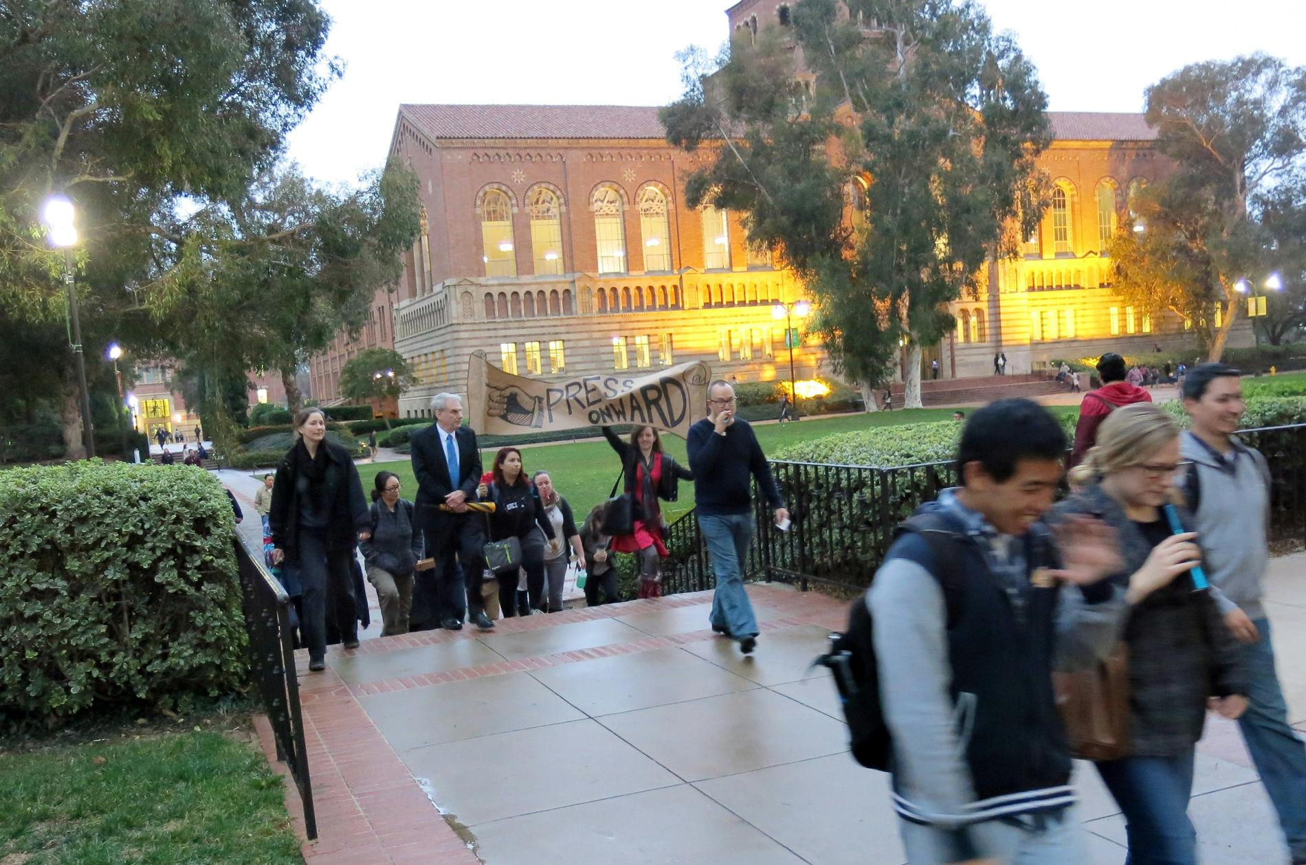 IS students held a parade from Powell Library to YRL to celebrate the ribbon cutting of antique printing press exhibits in the two libraries.