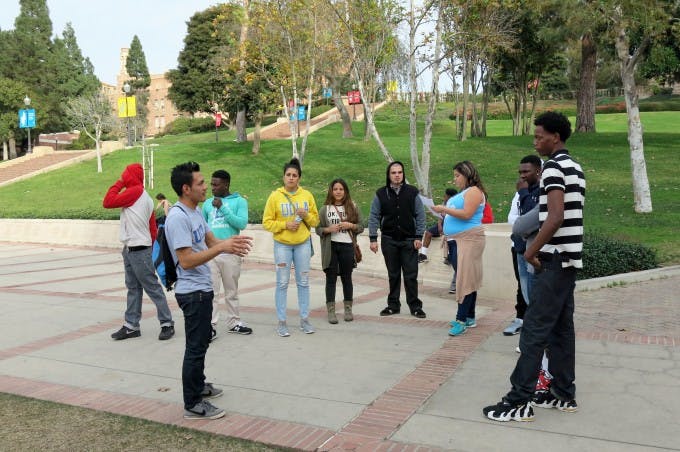 Edgar Carpinteyro, a third-year UCLA undergraduate majoring in Chicana/o studies with a minor in education (second from left), shared a glimpse of student life with potential college students from OneWay Outreach.