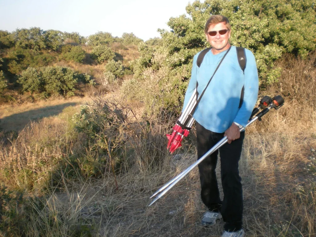 Robert Mechikoff carrying archaeological surveying equipment