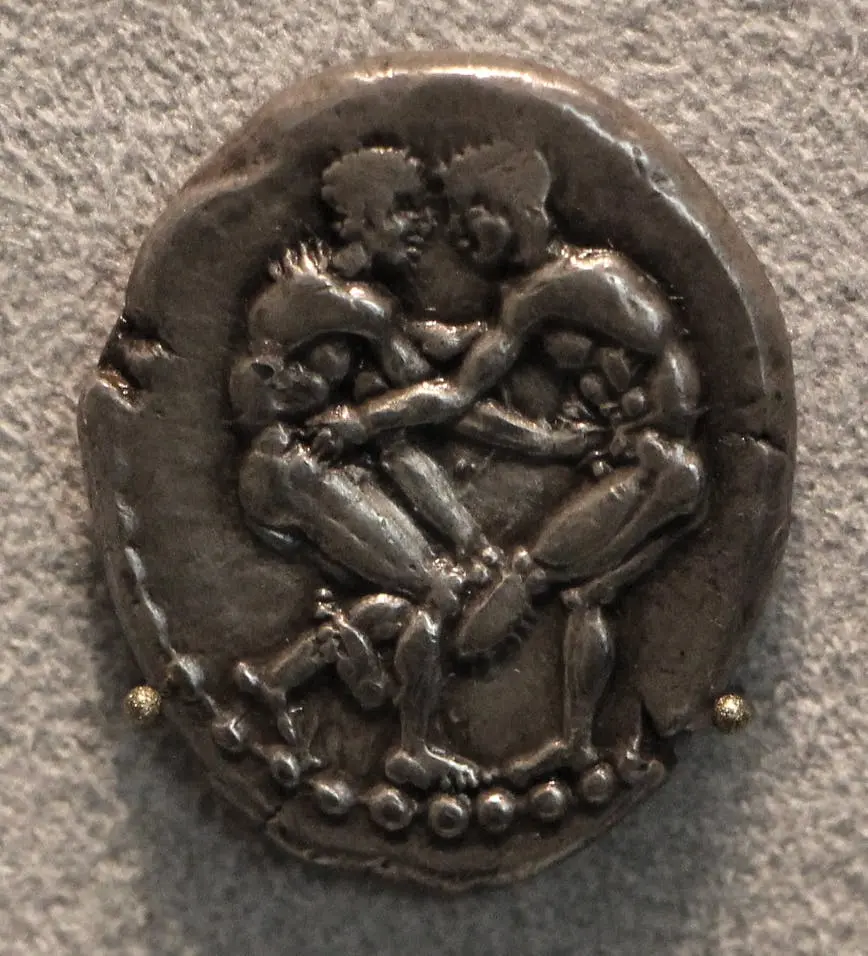 Ancient coin showing two wrestlers