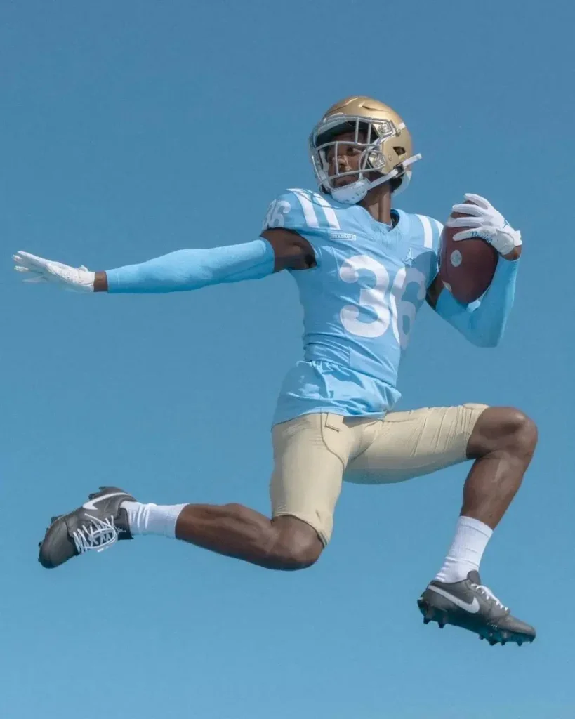 Alex Johnson holding a football