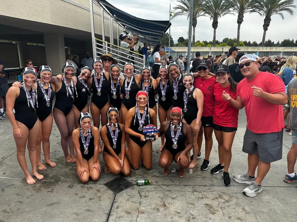 Bella Baia poses with the Los Angeles Premier Water Club’s 14-under girls squad