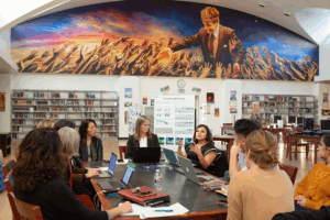 Education administrators discussing in a library