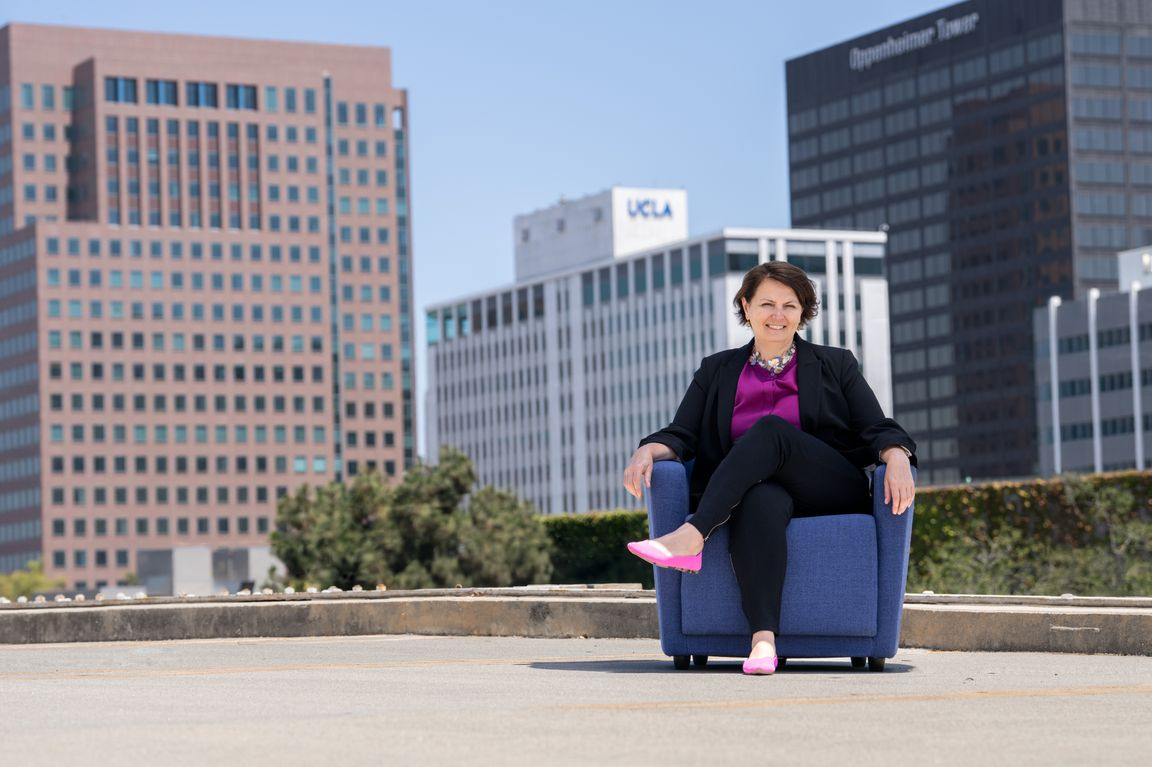 Michelle Caswell sitting on chair outdoors